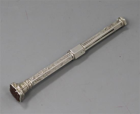 A late 19th/early 20th century white metal propelling pencil with carnelian set seal top.